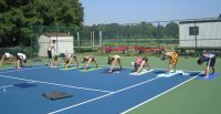 group yoga on our tennis court